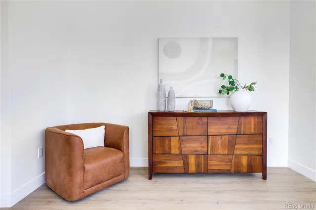 a blue couch sitting in a living room next to a window
