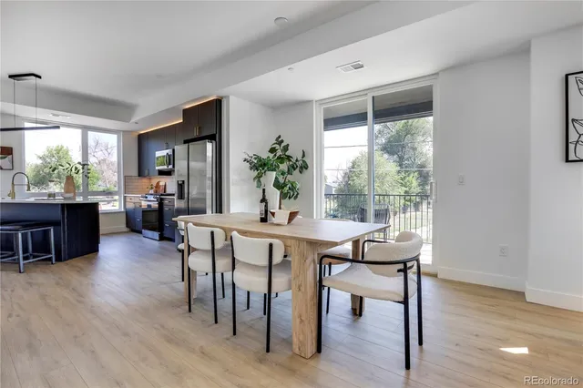 a view of a dining room with furniture window and wooden floor