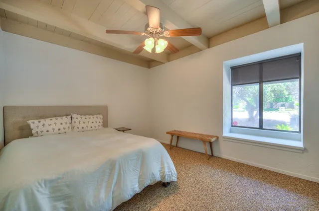 a spacious bathroom with a granite countertop sink and a mirror