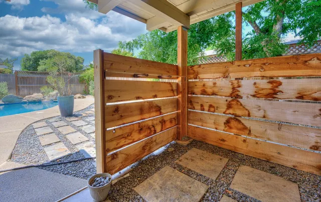 a view of a house with swimming pool and sitting area
