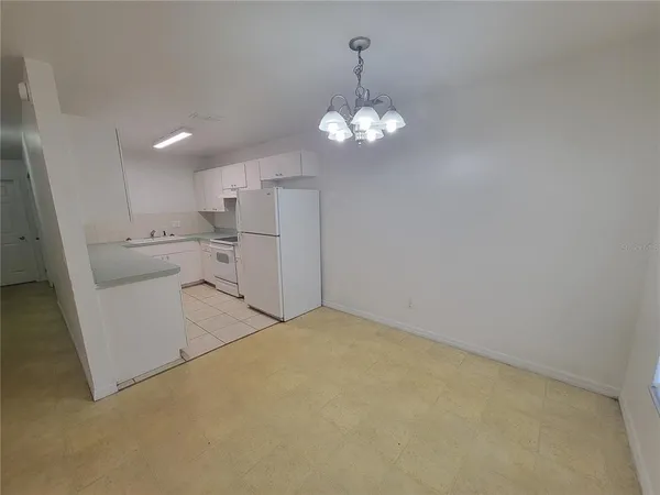 an empty room with wooden floor and ceiling fan