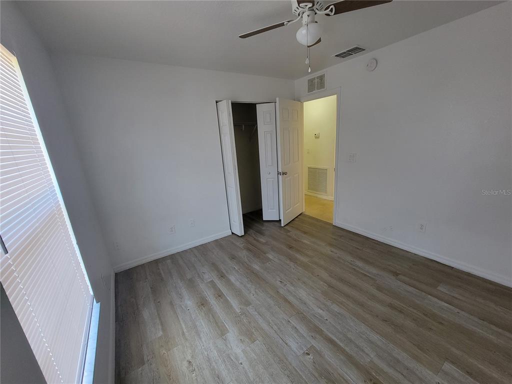 15755 Southwest 33rd Ave Road, Unit 1 Ocala, FL 34473 - Photo 7 of 9 wooden floor in an empty room with a window