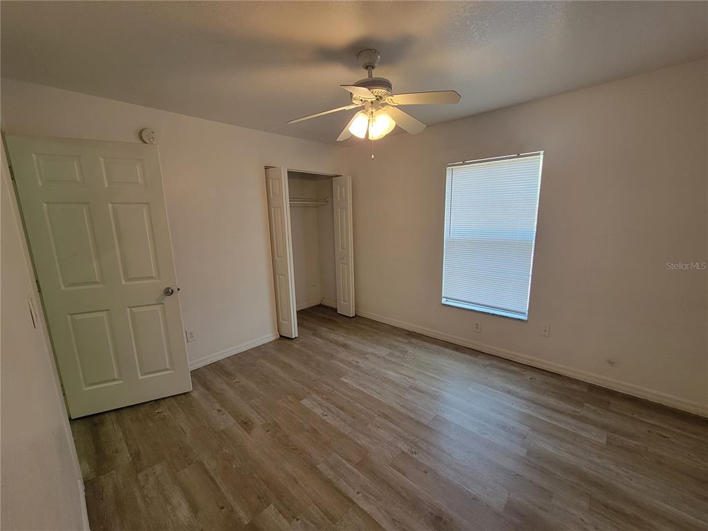 15755 Southwest 33rd Ave Road, Unit 1 Ocala, FL 34473 - Photo 8 of 9 a view of an empty room with wooden floor