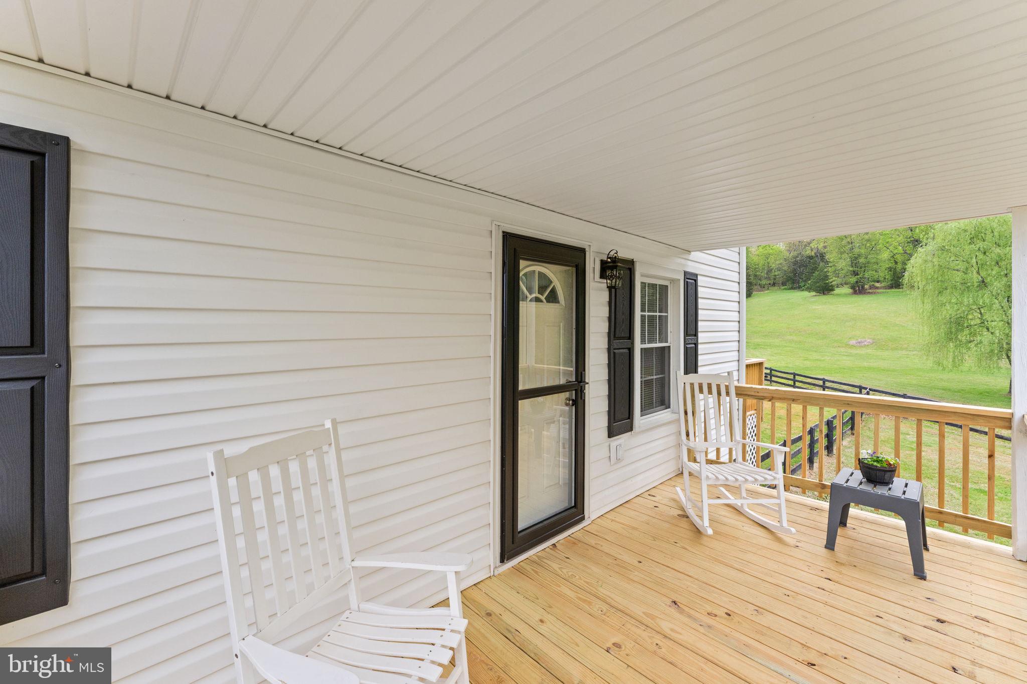 2459 Thoroughfare Road Culpeper, VA 22701 - Photo 16 of 59 a balcony with wooden floor table and chairs