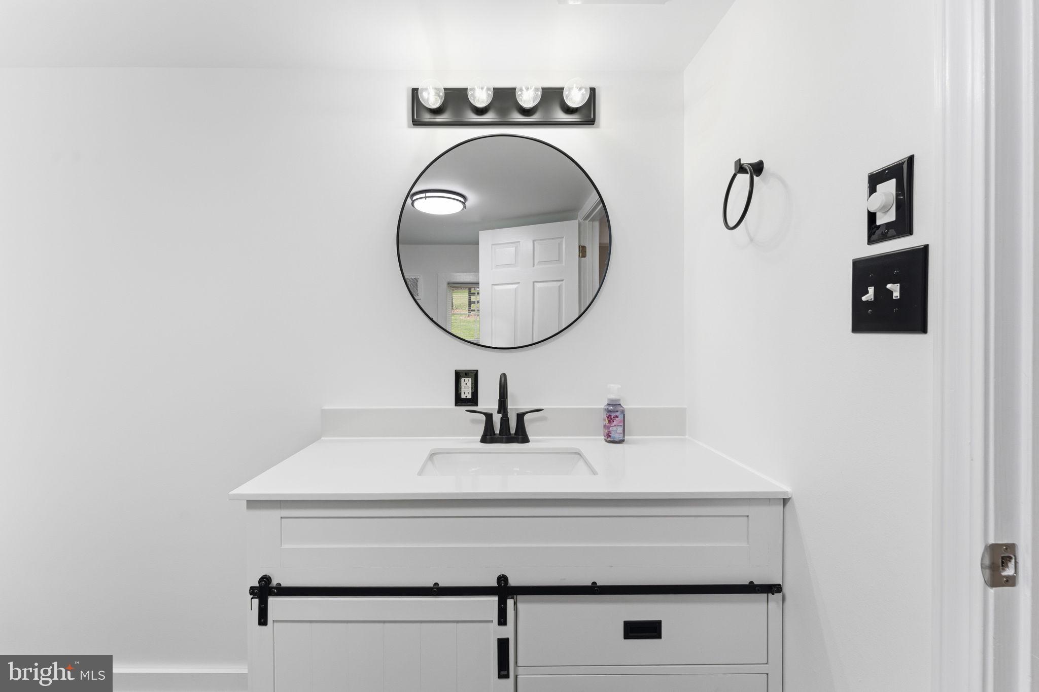 2459 Thoroughfare Road Culpeper, VA 22701 - Photo 28 of 59 a bathroom with a sink and a mirror