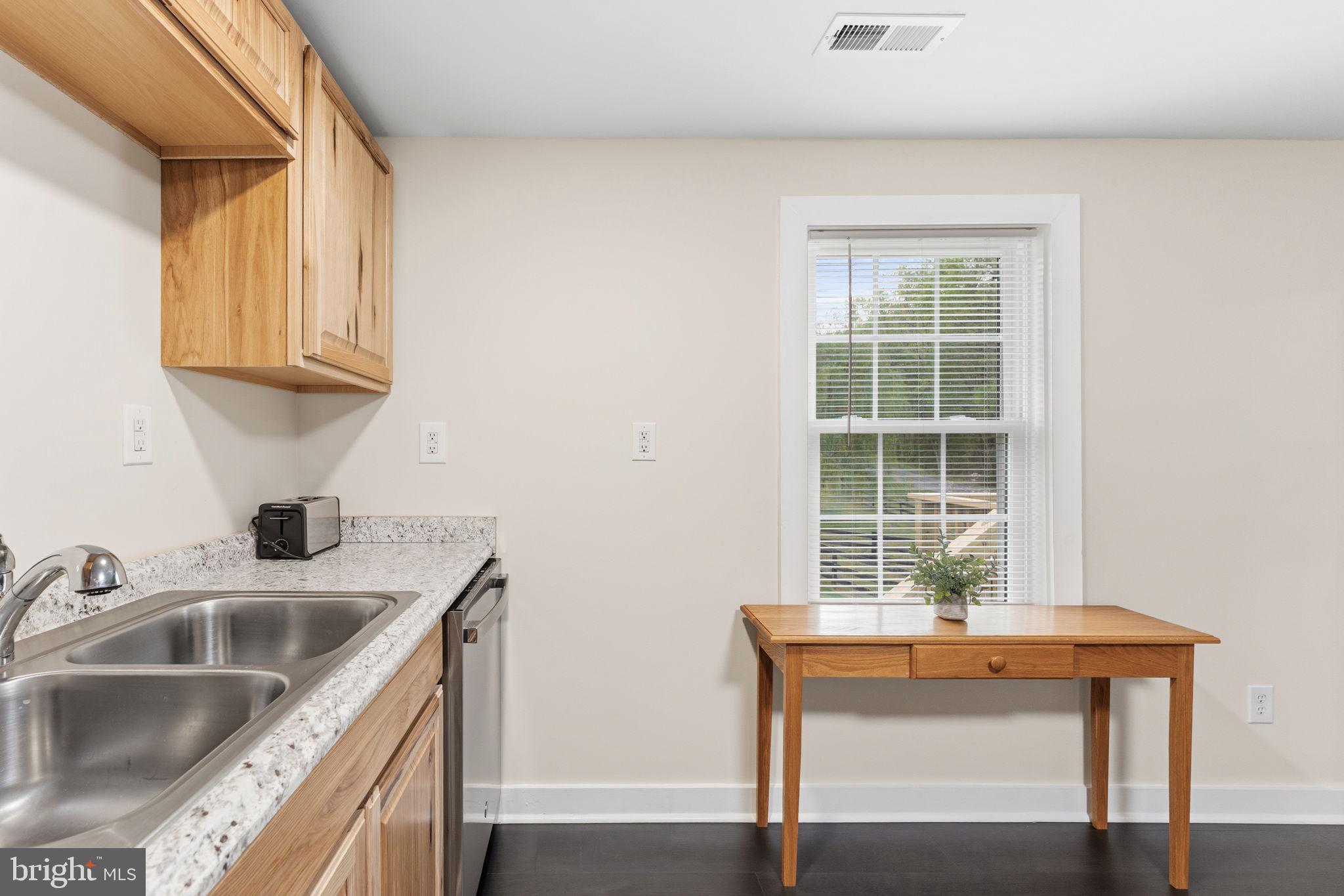 2459 Thoroughfare Road Culpeper, VA 22701 - Photo 32 of 59 a kitchen with stainless steel appliances granite countertop a sink a stove and a microwave oven