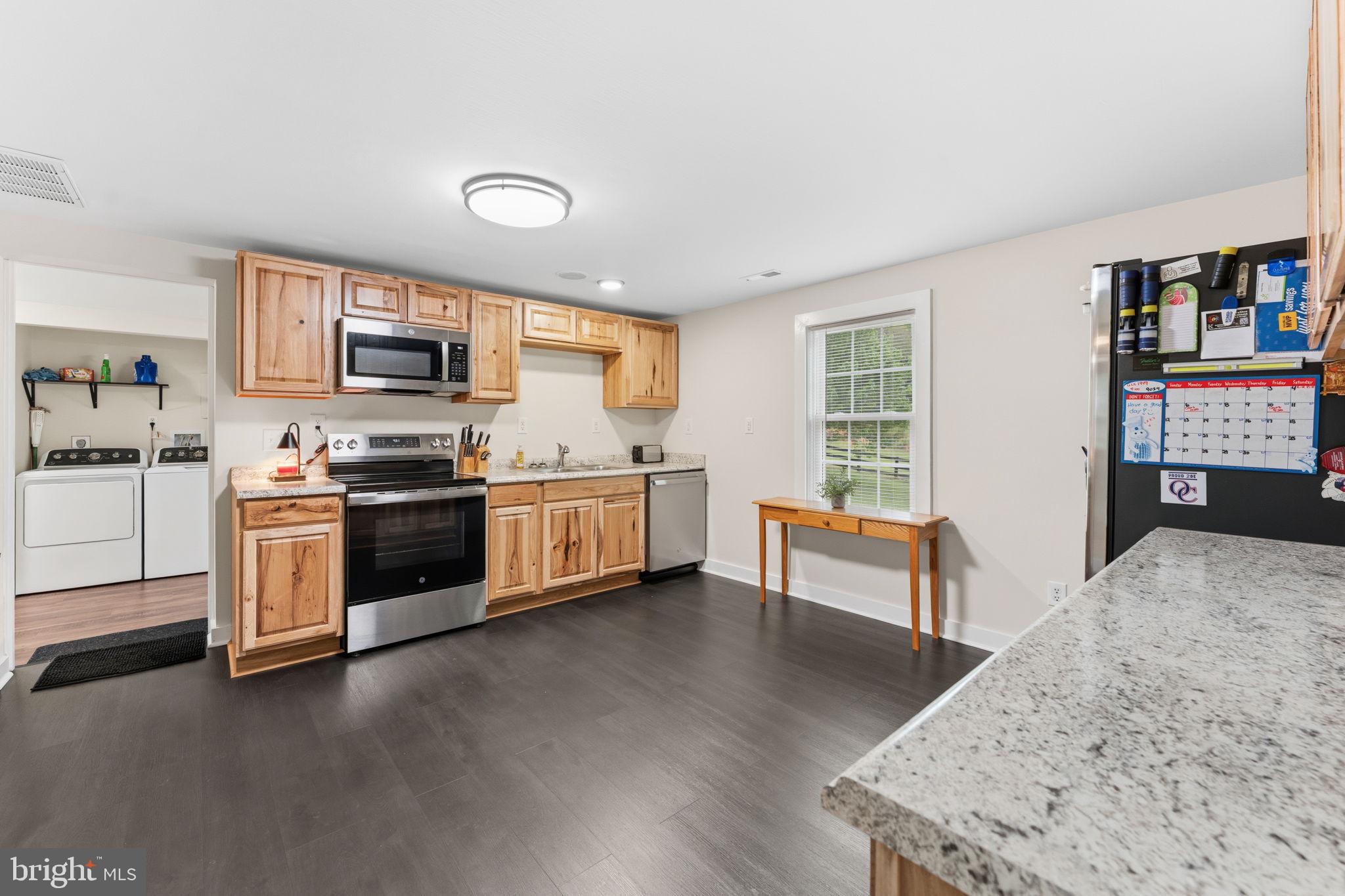 2459 Thoroughfare Road Culpeper, VA 22701 - Photo 35 of 59 a kitchen with stainless steel appliances kitchen island wooden cabinets and a refrigerator