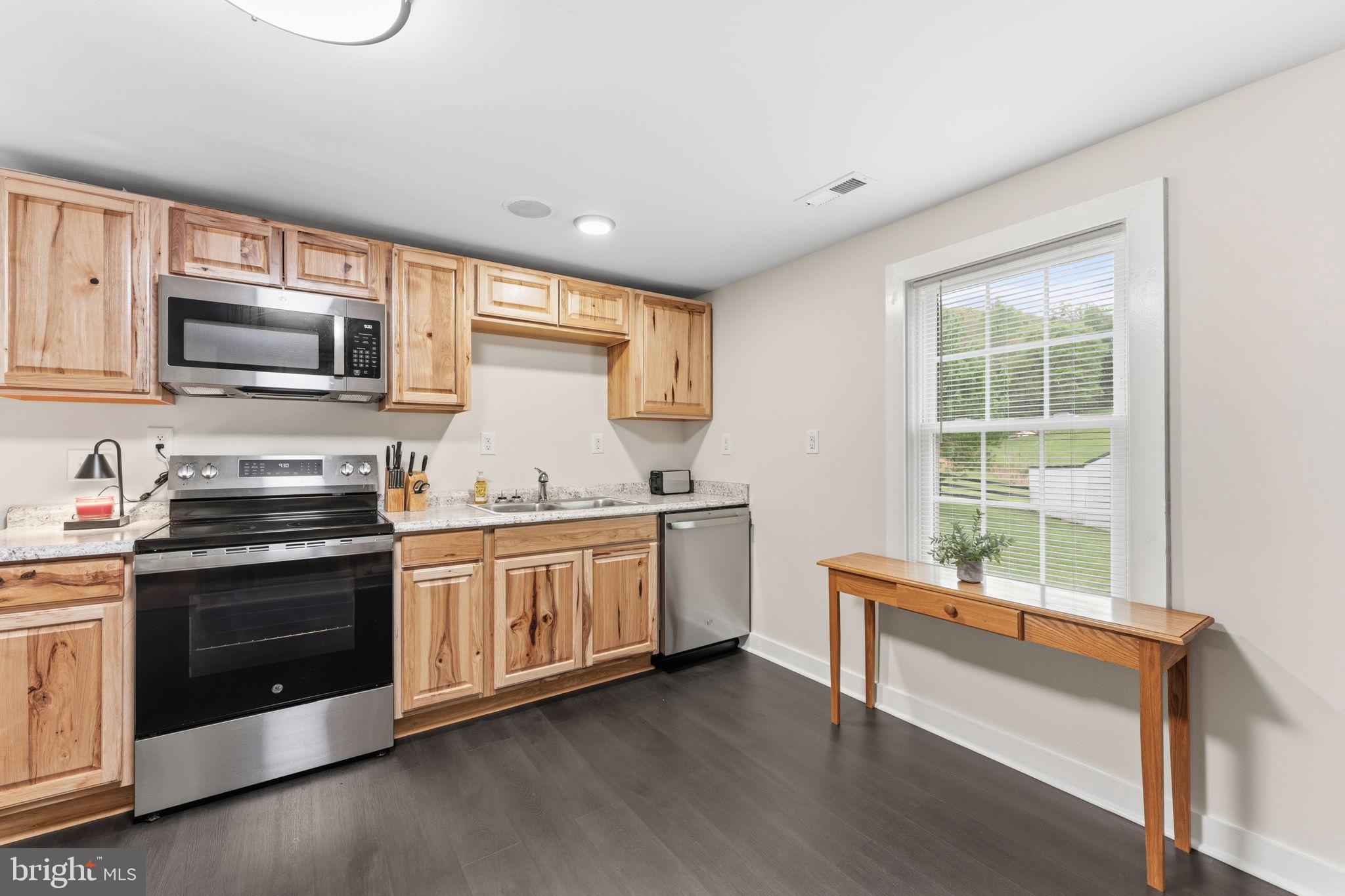 2459 Thoroughfare Road Culpeper, VA 22701 - Photo 37 of 59 a kitchen with granite countertop a stove a sink and a microwave