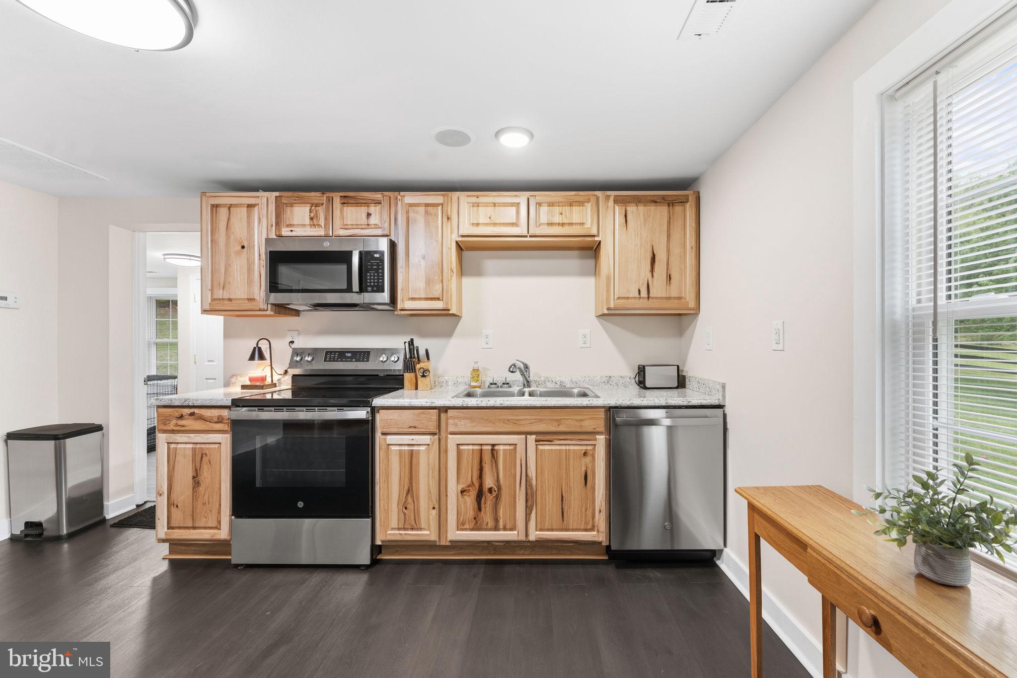 2459 Thoroughfare Road Culpeper, VA 22701 - Photo 38 of 59 a kitchen with stainless steel appliances granite countertop a stove and a white cabinets