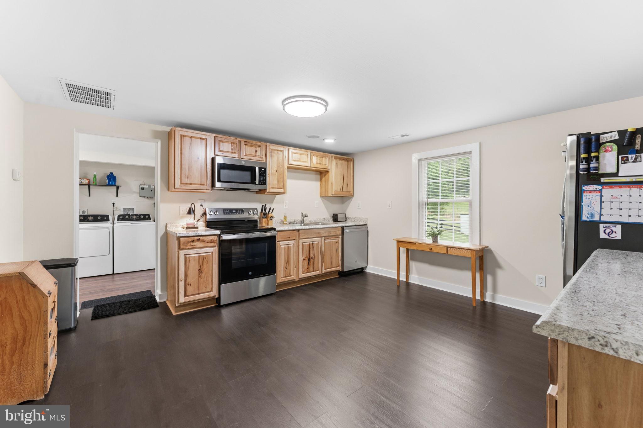 2459 Thoroughfare Road Culpeper, VA 22701 - Photo 45 of 59 a kitchen with granite countertop a stove a sink and a refrigerator