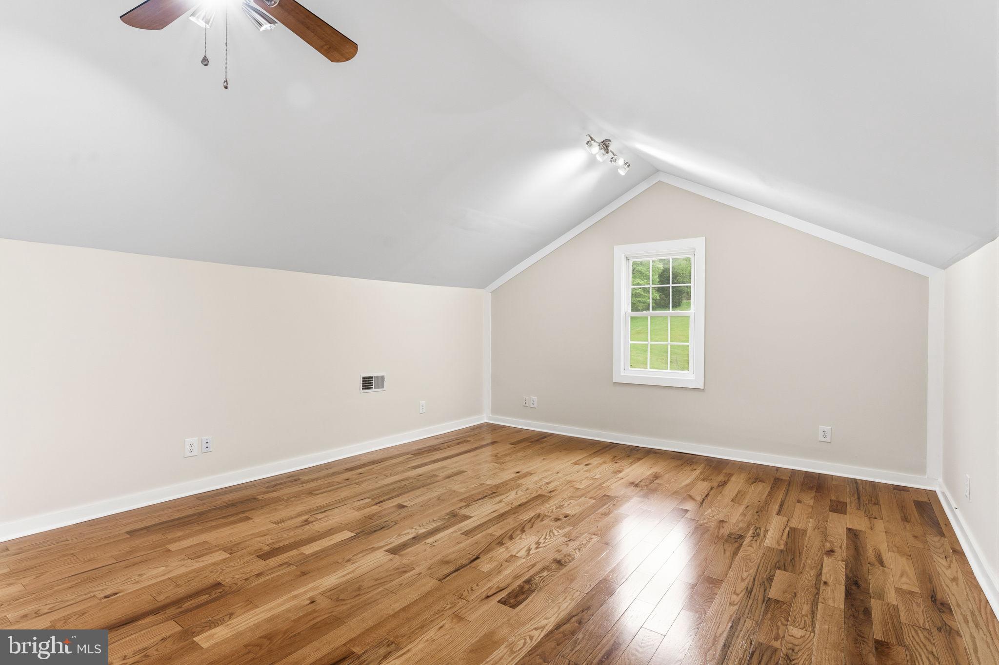 2459 Thoroughfare Road Culpeper, VA 22701 - Photo 55 of 59 an empty room with wooden floor fan and windows
