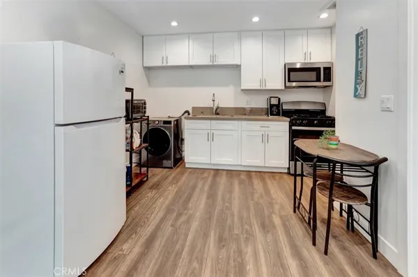 a kitchen with a refrigerator and a stove top oven