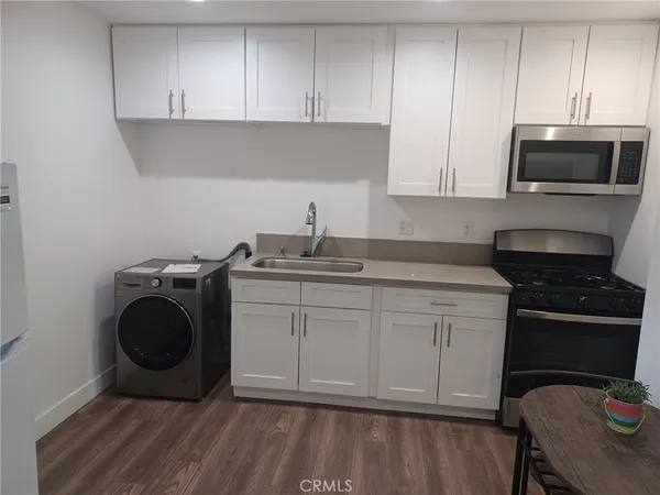 a kitchen with a sink and a stove top oven