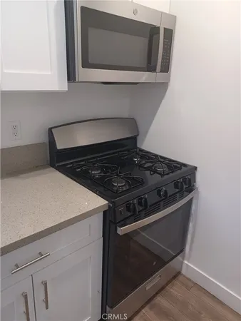 a stove top oven sitting inside of a kitchen