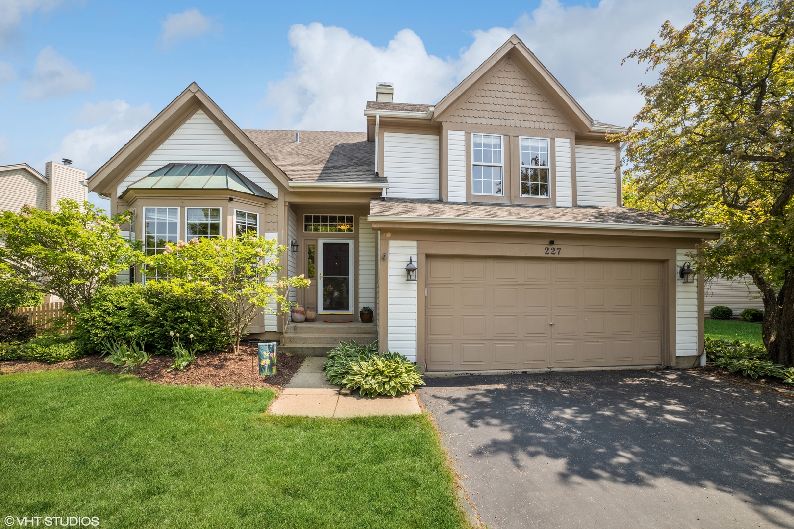 a front view of a house with a yard and garage