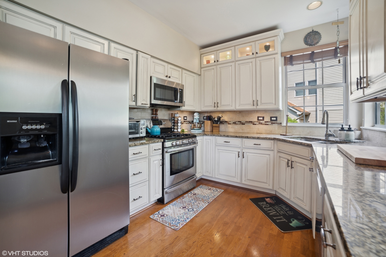 227 Shawnee Circle Bartlett, IL 60103 - Photo 6 of 21 a kitchen with a refrigerator sink and cabinets