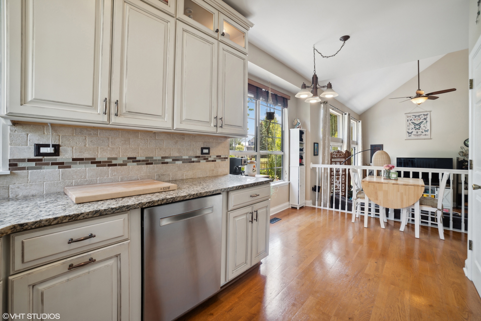 227 Shawnee Circle Bartlett, IL 60103 - Photo 7 of 21 a kitchen with stainless steel appliances granite countertop a stove a sink dishwasher and white cabinets with wooden floor