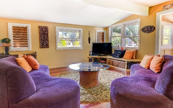 4449 Mahimahi Road Hanalei, HI 96714 - Photo 15 of 20 a living room with furniture a flat screen tv and a large window