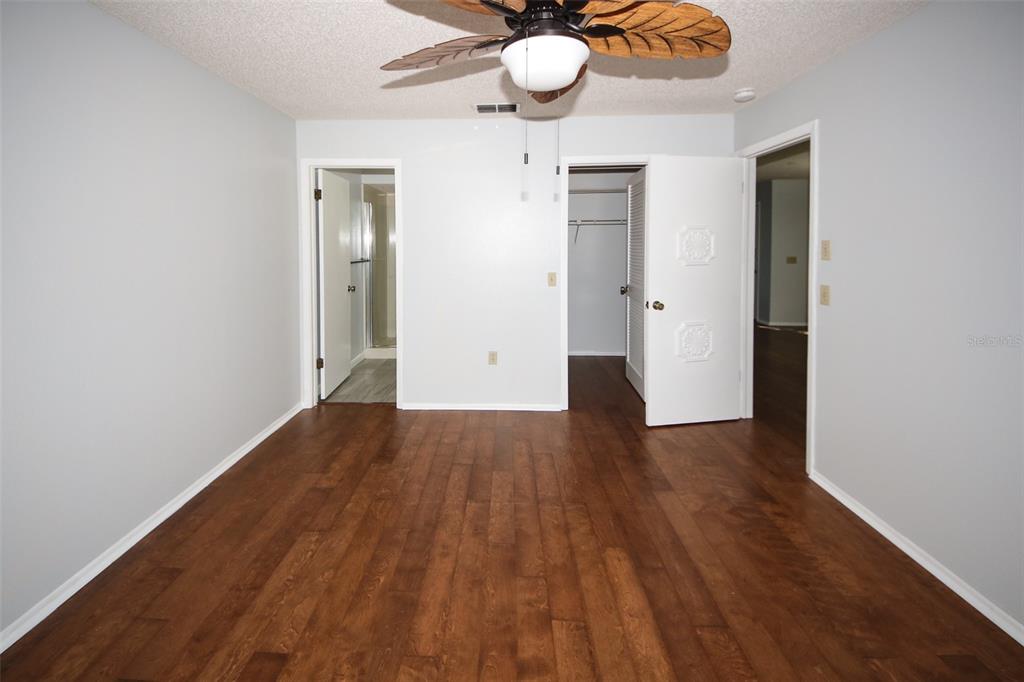 13009 Wedgewood Way, Unit C Hudson, FL 34667 - Photo 17 of 25 a view of an empty room and wooden floor