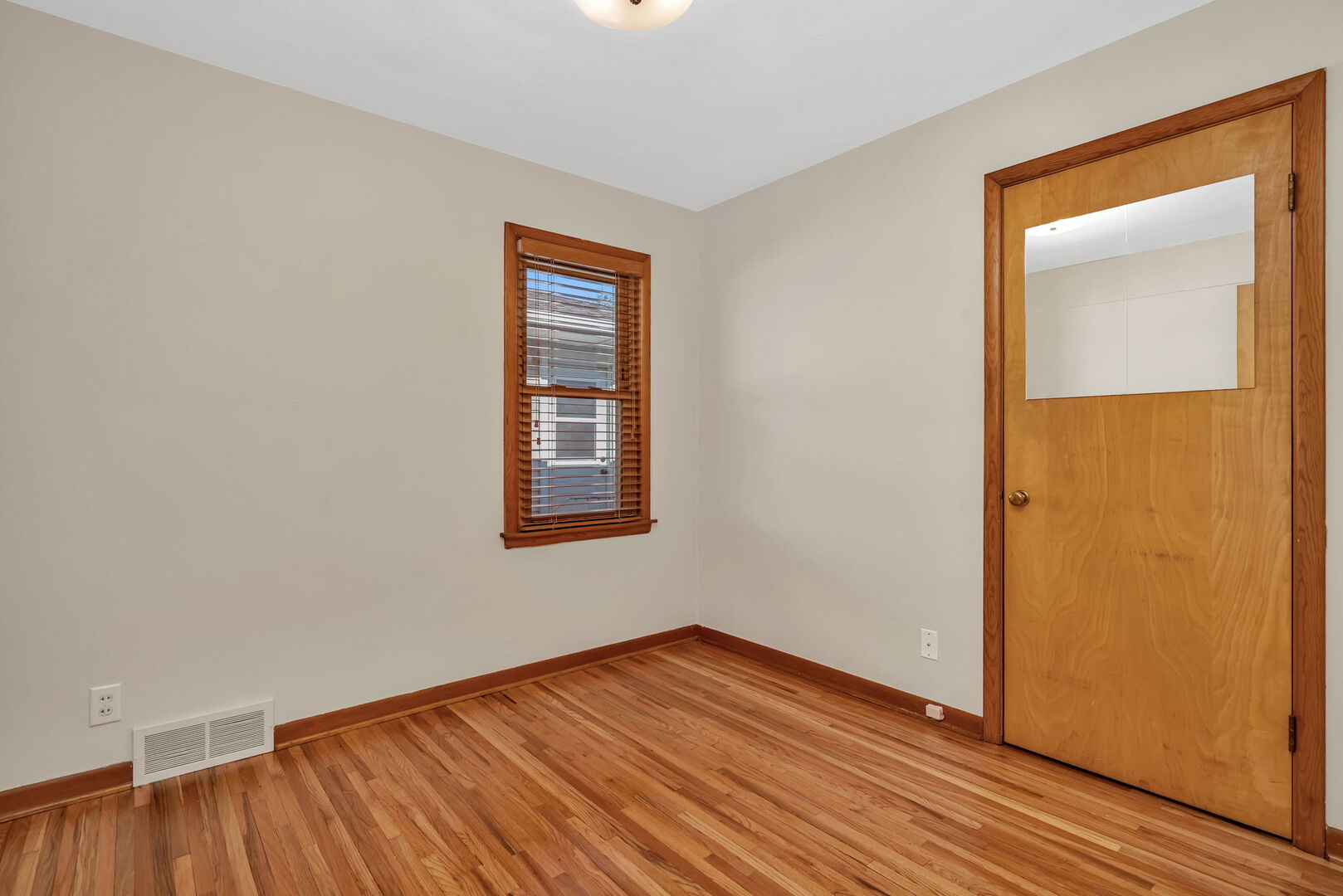 206 South Reed Street Joliet, IL 60436 - Photo 12 of 27 a view of an empty room with wooden floor and a window