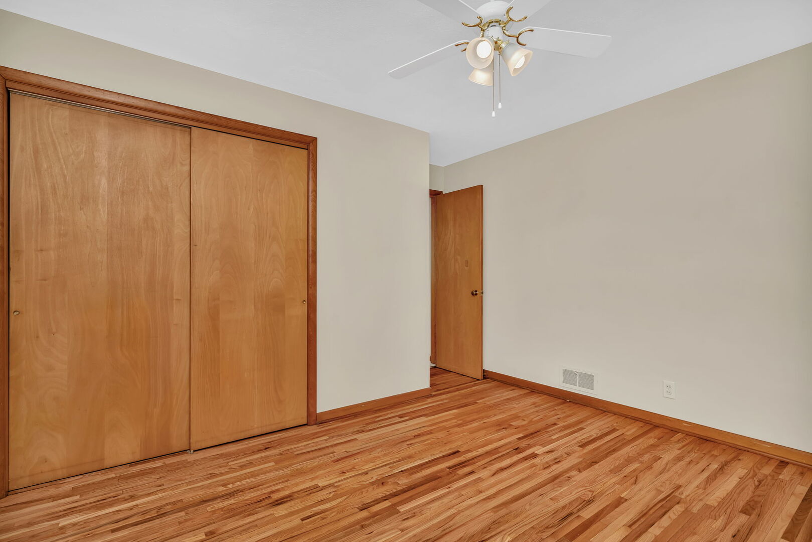 206 South Reed Street Joliet, IL 60436 - Photo 15 of 27 a view of an empty room with wooden floor and a window