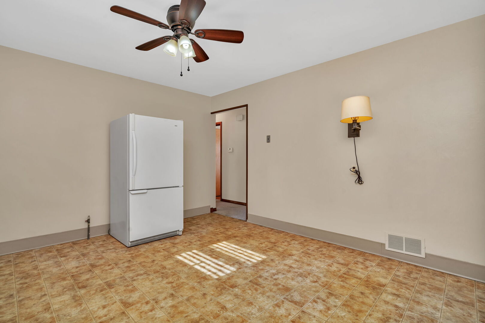 206 South Reed Street Joliet, IL 60436 - Photo 9 of 27 a view of a livingroom with a chandelier fan and kitchen view