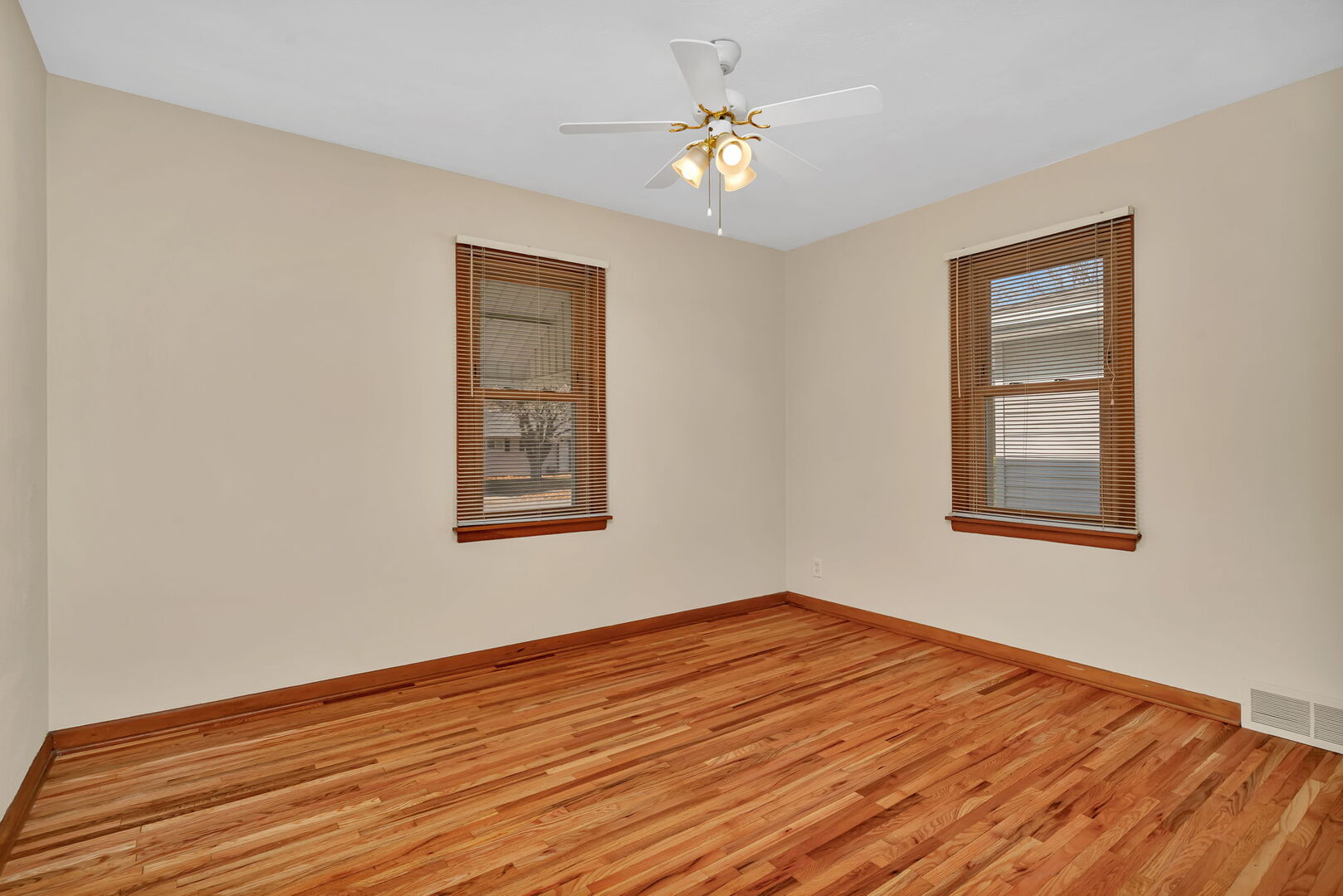 206 South Reed Street Joliet, IL 60436 - Photo 10 of 27 a view of an empty room with window and wooden floor