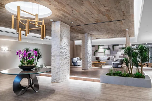 a lobby with furniture and floor to ceiling windows