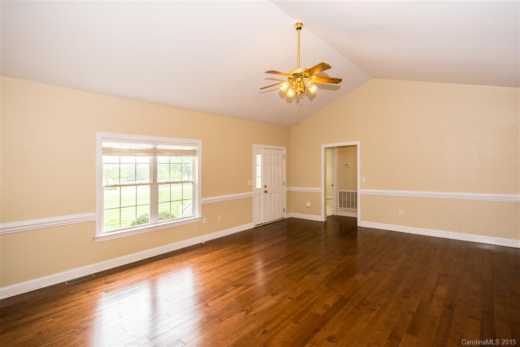 4419 Zack Road Monroe, NC 28110 - Photo 2 of 17 a view of an empty room with a window and wooden floor