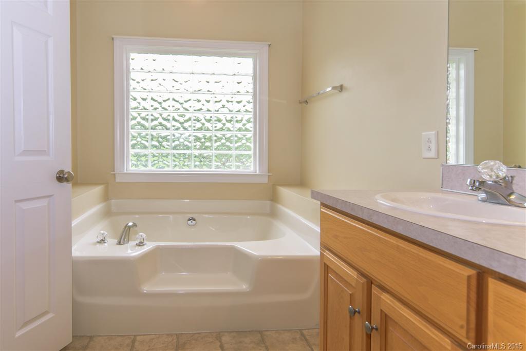 4419 Zack Road Monroe, NC 28110 - Photo 12 of 17 a bathroom with a tub sink and mirror