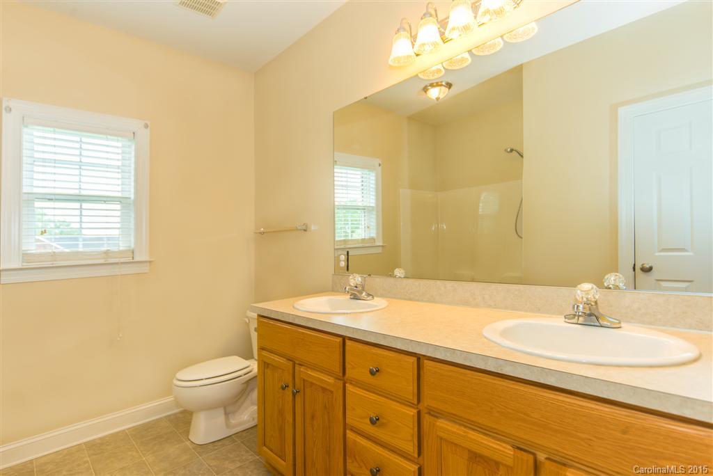 4419 Zack Road Monroe, NC 28110 - Photo 14 of 17 a bathroom with a sink a toilet and a mirror