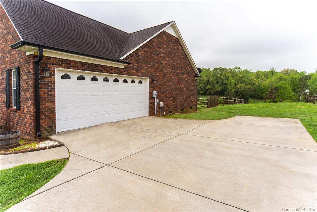 4419 Zack Road Monroe, NC 28110 - Photo 15 of 17 a front view of a house with a yard and garage