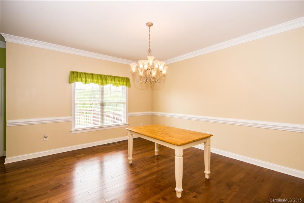 4419 Zack Road Monroe, NC 28110 - Photo 5 of 17 a dining room with wooden floor and a chandelier