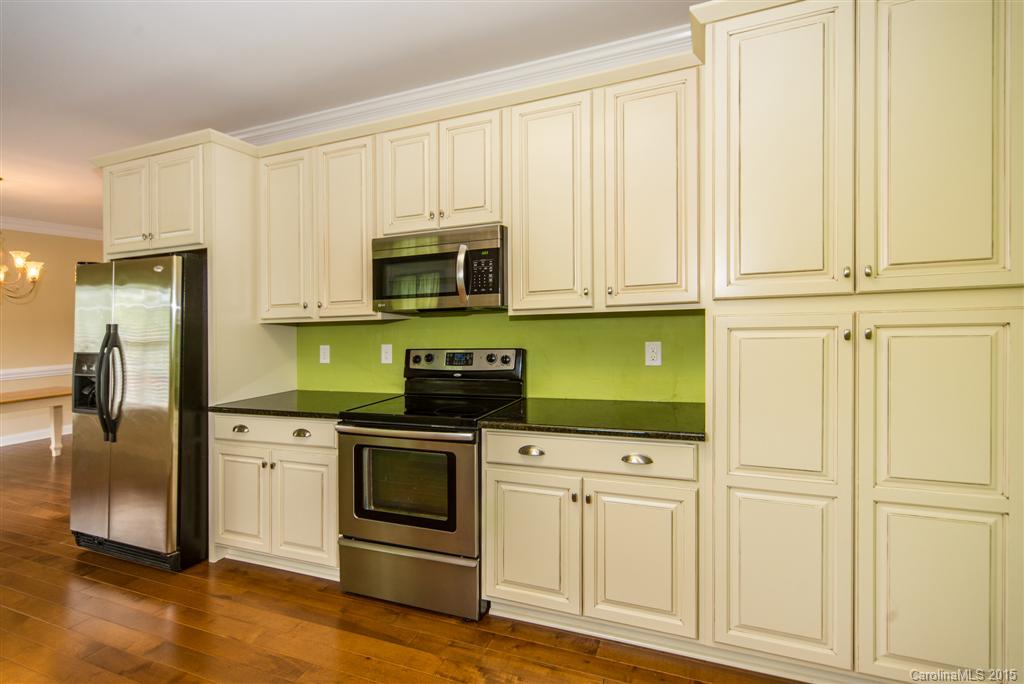 4419 Zack Road Monroe, NC 28110 - Photo 8 of 17 a kitchen with white cabinets and stainless steel appliances