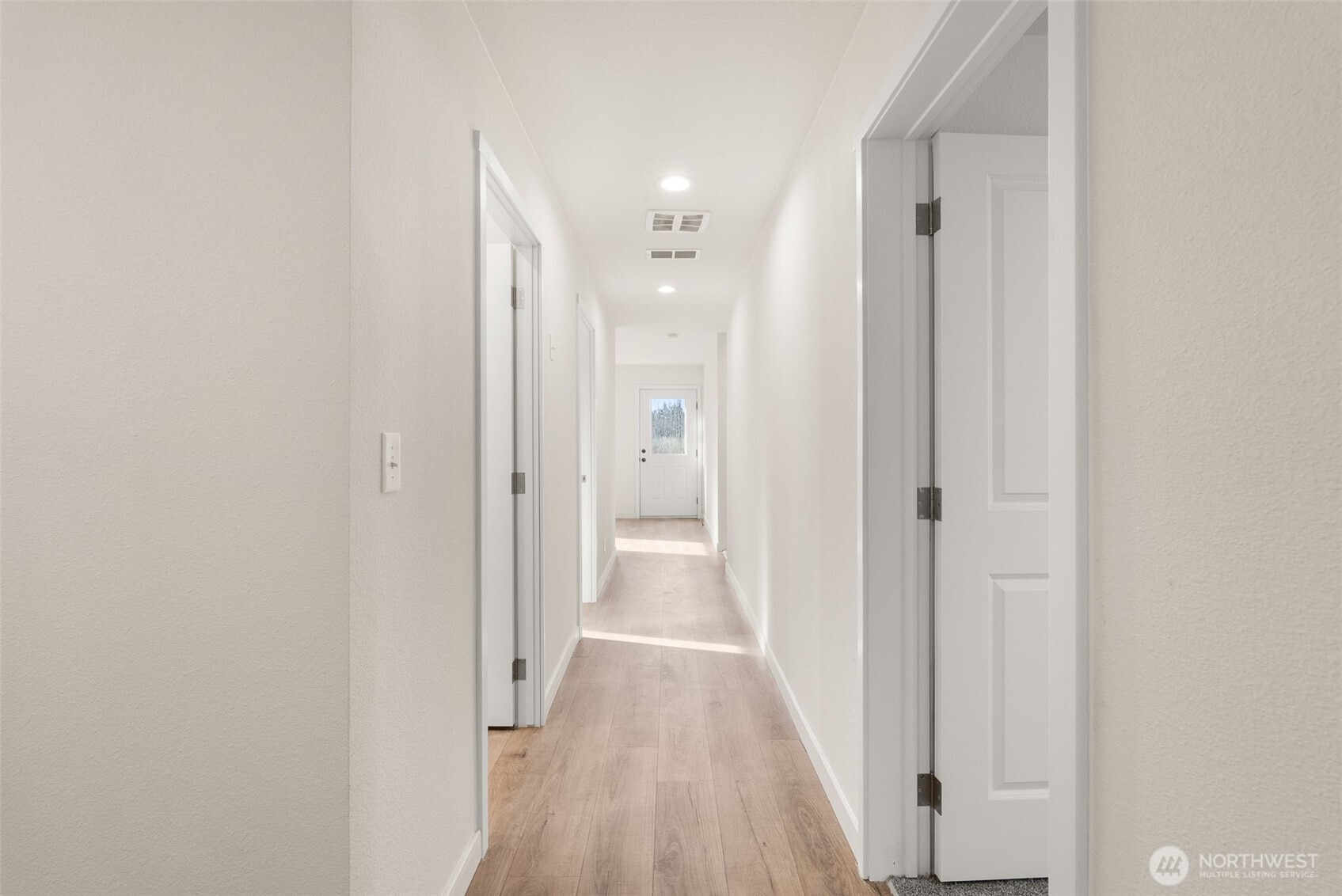 1110 Koontz Road Chehalis, WA 98532 - Photo 18 of 33 a view of a hallway with wooden floor and a bathroom