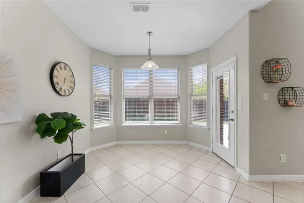 a vase of flowers sitting on a table in a room