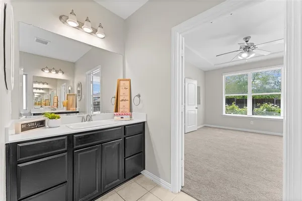 a bathroom with a double vanity sink and a mirror
