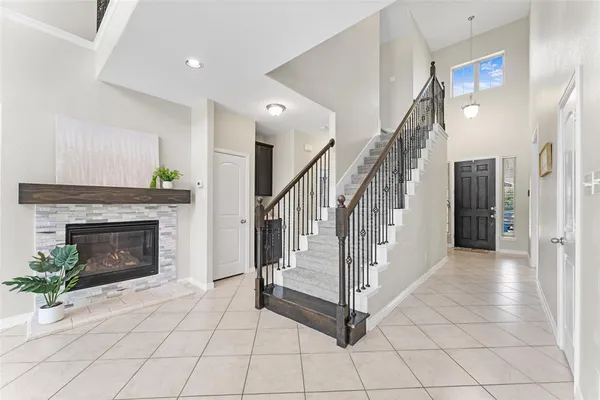 a view of a livingroom with a fireplace and stairs