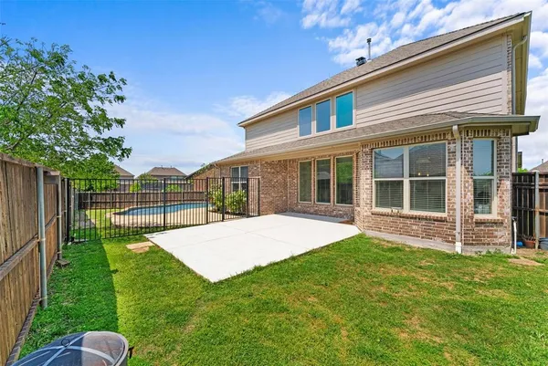 a view of a backyard with table and chairs and potted plants