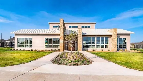 a front view of a building with a garden