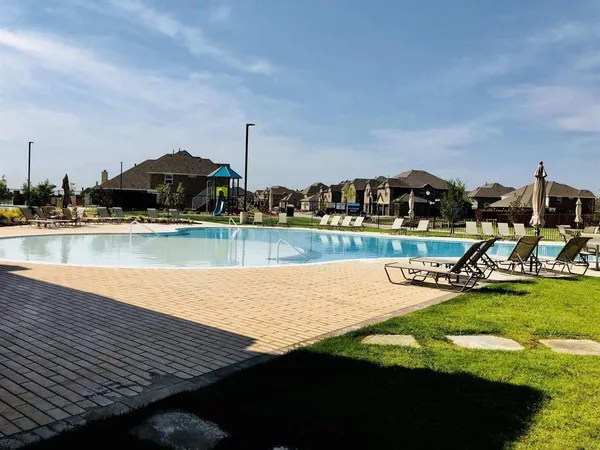 a view of a lake with houses in the back