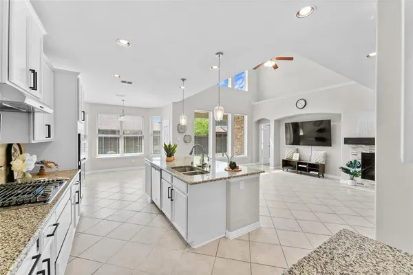 a large white kitchen with a large window