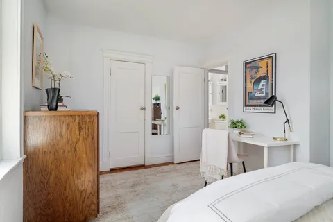 a bedroom with a bed and a table in it