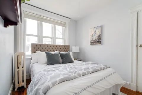 a bedroom with a large bed and a window