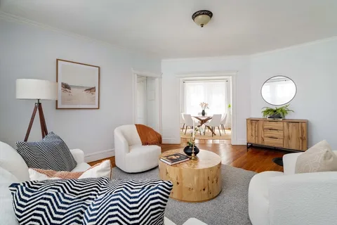 a living room with furniture and a lamp