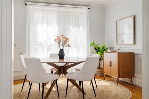 a view of a dining room with furniture and a window