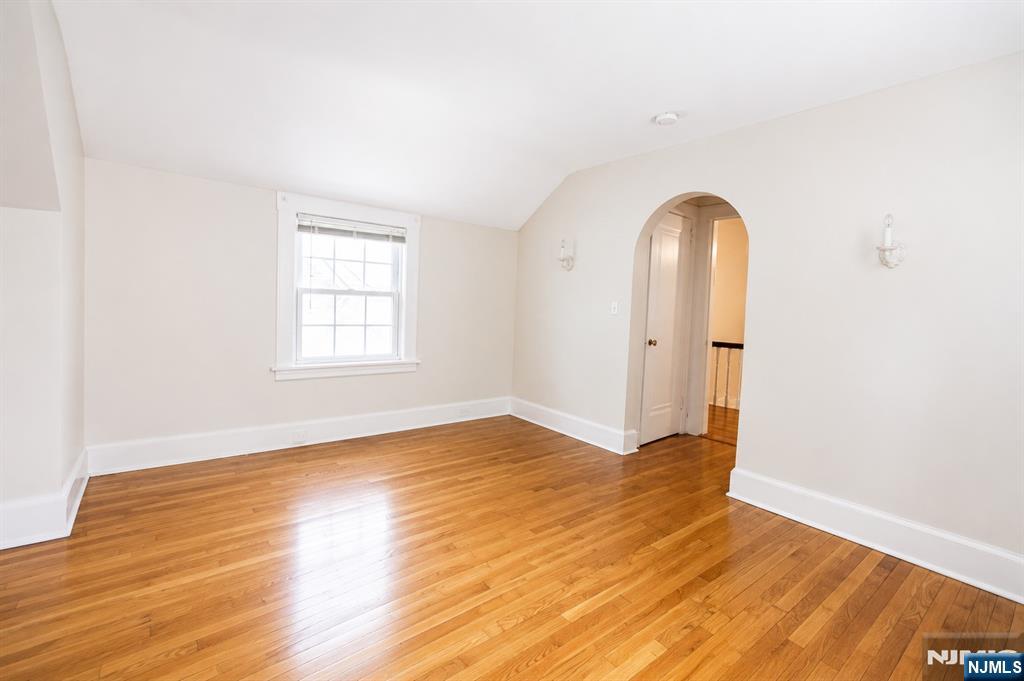 298 Audubon Road Englewood, NJ 07631 - Photo 15 of 19 an empty room with wooden floor and windows