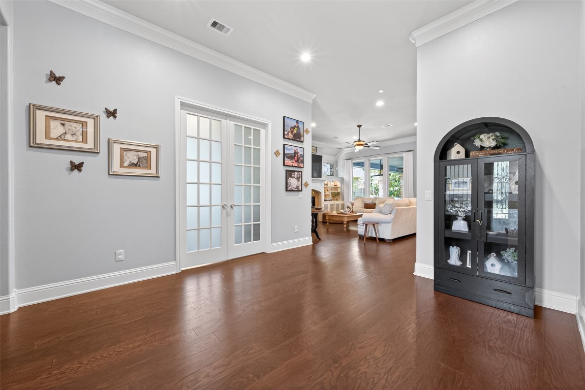 19852 Cullen Ridge Drive Porter, TX 77365 - Photo 10 of 43 Upon entering the home, you're welcomed by a bright, open foyer with hardwood floors. French doors lead into the study or optional third bedroom, while a conveniently located half bath sits just to the right.