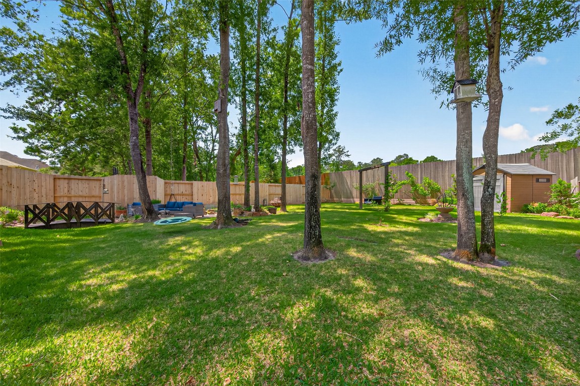 19852 Cullen Ridge Drive Porter, TX 77365 - Photo 30 of 43 Large back yard with lush greenery and high fences for privacy. Entire home sits on nearly a third of an acre.