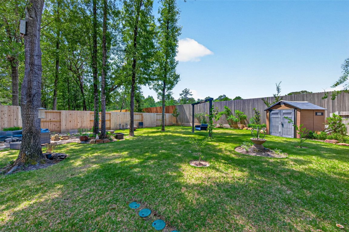 19852 Cullen Ridge Drive Porter, TX 77365 - Photo 32 of 43 Large back yard with lush greenery and high fences for privacy. Entire home sits on nearly a third of an acre.